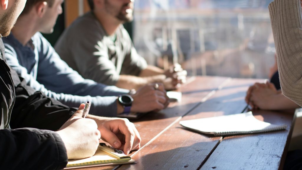 Members of a paid professional community meeting around a table